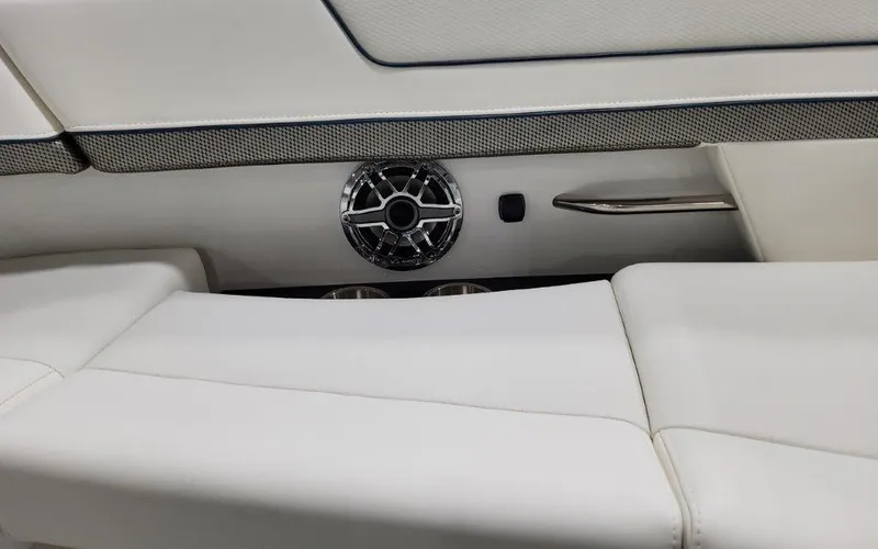 Slide: The Image of 2025 Formula 310 Bowrider I/O interior with white seating and speaker detail. - 15