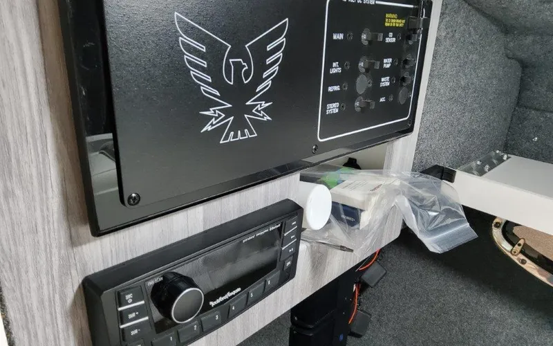 Slide: The Image of Control panel and audio system inside 2025 Formula 310 Bowrider I/O boat cabin. - 19