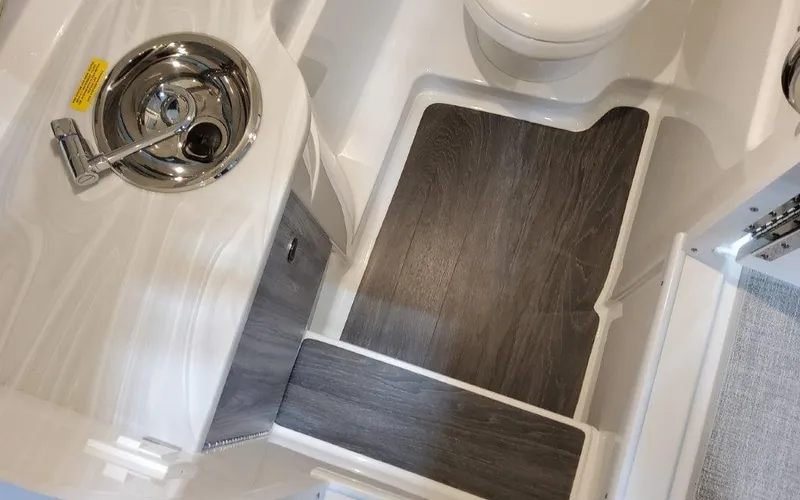 Slide: The Image of 2025 Formula 310 Bowrider I/O interior with sink and wood-style flooring. - 22