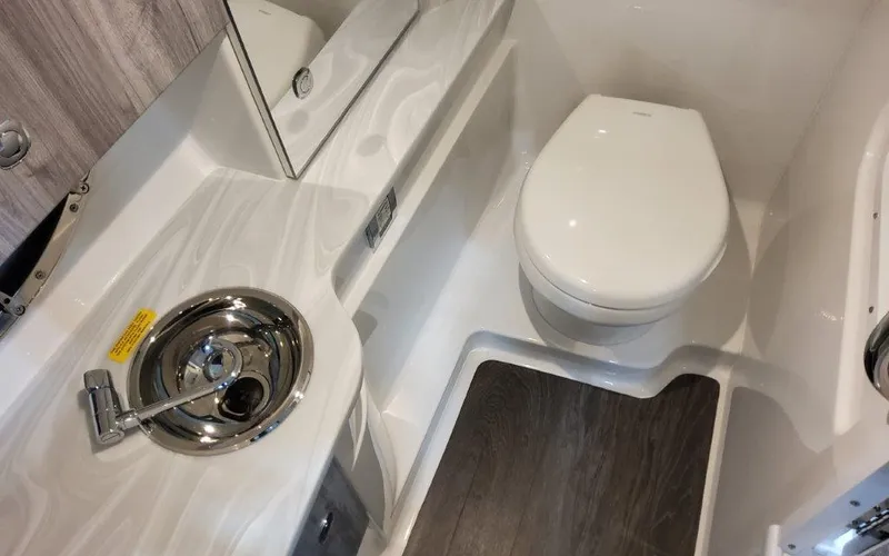 Slide: The Image of 2025 Formula 310 Bowrider I/O boat bathroom with sink and toilet. - 23