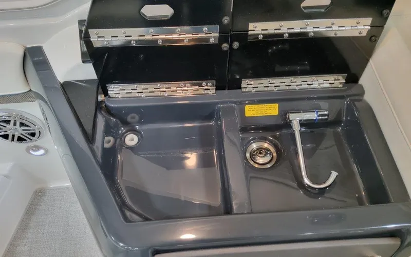 Slide: The Image of 2025 Formula 310 Bowrider I/O sink area with modern fixtures and storage compartments. - 34