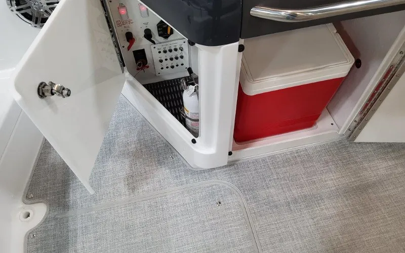 Slide: The Image of 2025 Formula 310 Bowrider I/O interior storage with cooler and control panel. - 35