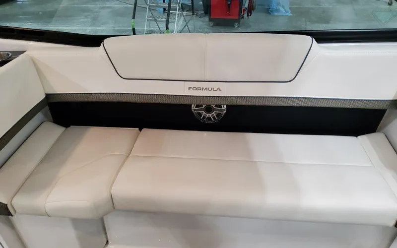 Slide: The Image of 2025 Formula 310 Bowrider I/O boat interior with white seating and logo detail. - 37