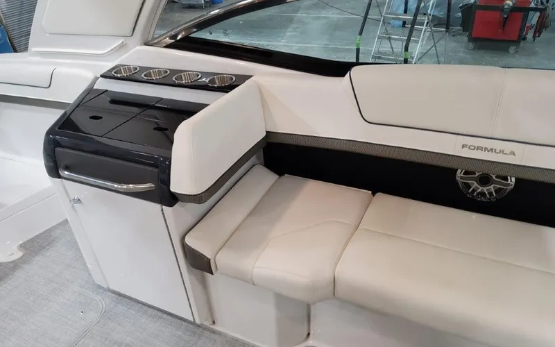 Slide: The Image of 2025 Formula 310 Bowrider I/O interior with white seating and sleek design. - 38
