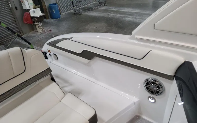 Slide: The Image of 2025 Formula 310 Bowrider I/O interior with white seating and speaker detail. - 39