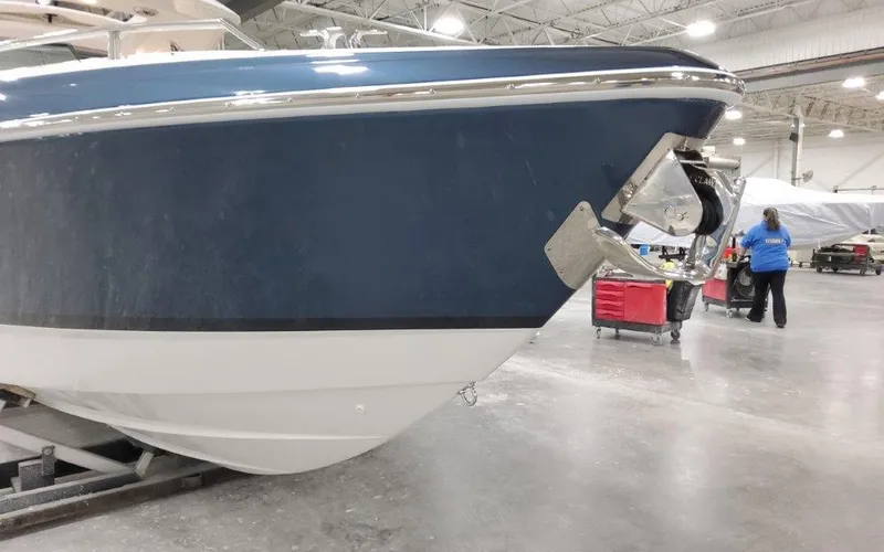 Slide: The Image of 2025 Formula 310 Bowrider I/O boat in a warehouse setting. - 4