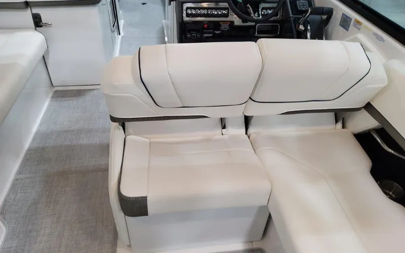 Slide: The Image of 2025 Formula 310 Bowrider I/O interior with white seating and modern dashboard. - 44