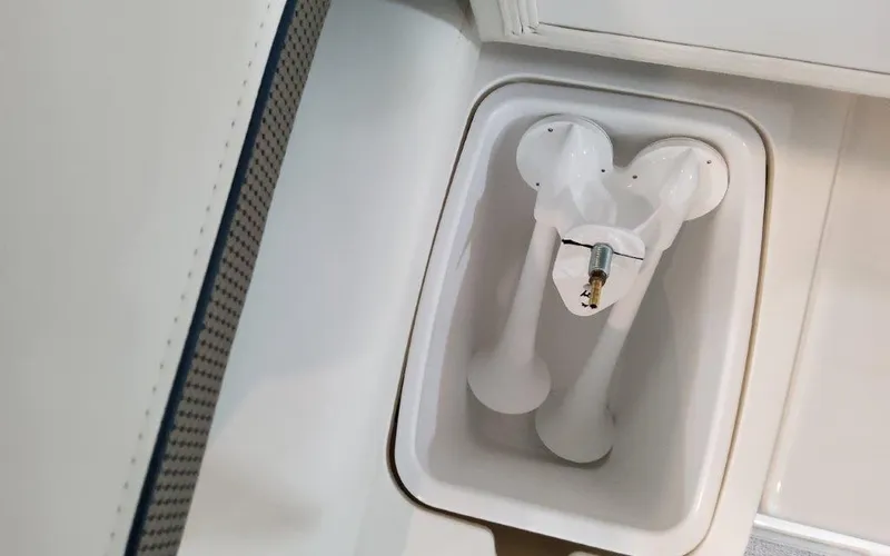 Slide: The Image of 2025 Formula 310 Bowrider I/O boat horn compartment with dual white horns. - 48