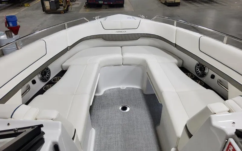 Slide: The Image of 2025 Formula 310 Bowrider I/O interior with white seating and modern design. - 7