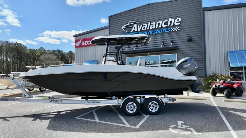 The Image of 2025 Starcraft SVX 231 OB boat on trailer at Avalanche Motorsports dealership. - 1