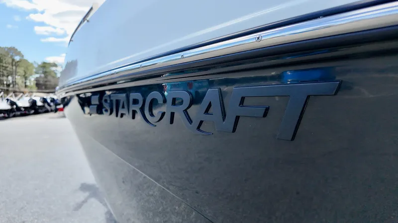 Slide: The Image of 2025 Starcraft SVX 231 OB boat, close-up of logo on sleek hull. - 4