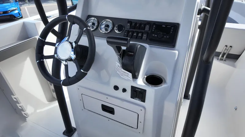 Slide: The Image of 2025 Starcraft SVX 231 OB boat console with steering wheel and controls. - 8