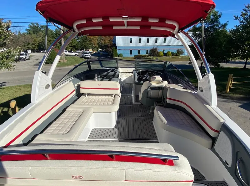 Slide: The Image of 2021 Cobalt R7 boat interior with red canopy and white seating. - 3