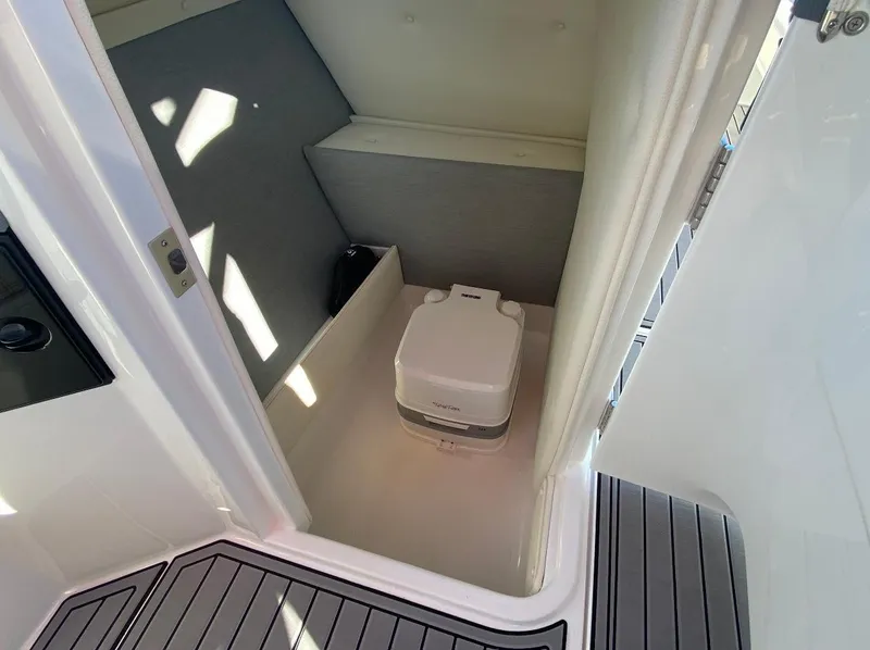 Slide: The Image of 2021 Cobalt R7 boat interior with compact portable toilet. - 5