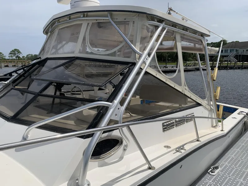 Slide: The Image of 2001 Carolina Classic 28 boat docked by the water. - 0