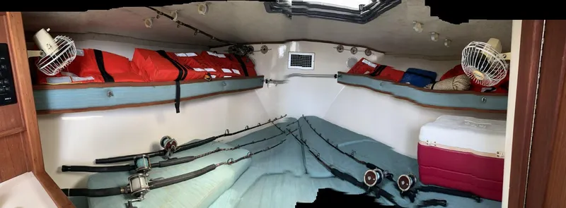 Slide: The Image of Interior of 2001 Carolina Classic 28 boat with fishing rods and life jackets. - 13
