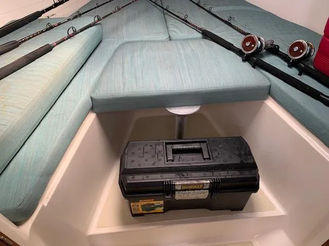 Slide: The Image of Interior of 2001 Carolina Classic 28 boat with fishing rods and tackle box. - 14