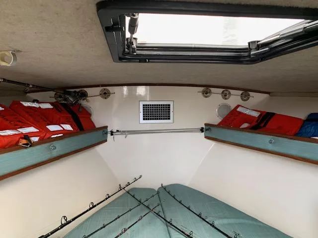 Slide: The Image of Interior of 2001 Carolina Classic 28 boat with fishing rods and life jackets. - 15