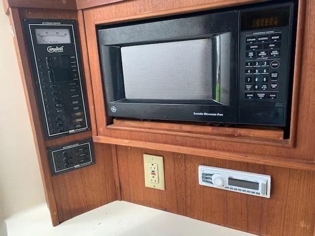 Slide: The Image of Microwave and control panel in 2001 Carolina Classic 28 boat interior. - 19