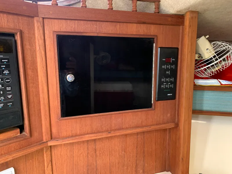 Slide: The Image of Wooden interior of 2001 Carolina Classic 28 with built-in microwave. - 20