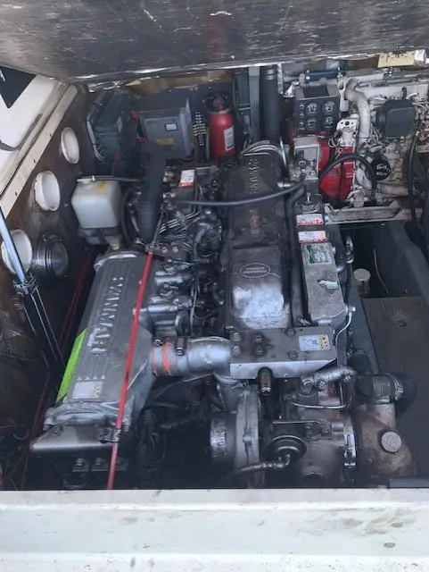 Slide: The Image of Engine compartment of a 2001 Carolina Classic 28 boat, showcasing detailed mechanical components. - 23