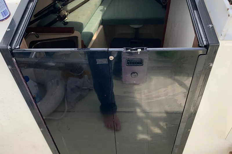 Slide: The Image of 2001 Carolina Classic 28 cabin entrance with black door and interior view. - 32