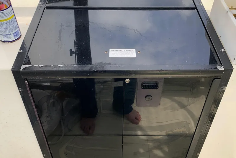 Slide: The Image of Black storage compartment on a 2001 Carolina Classic 28 boat deck. - 33