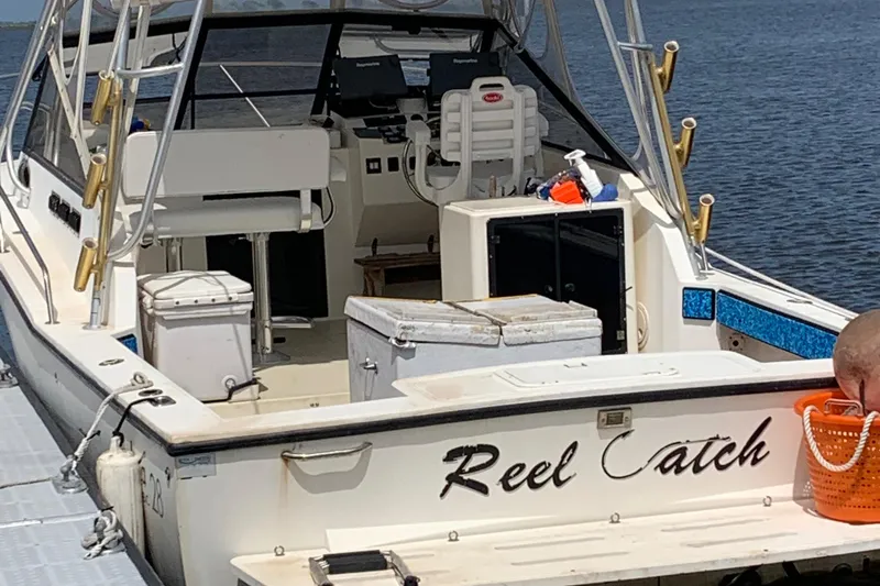 Slide: The Image of Carolina Classic 28 boat, 2001 model, docked with fishing gear and equipment visible. - 34