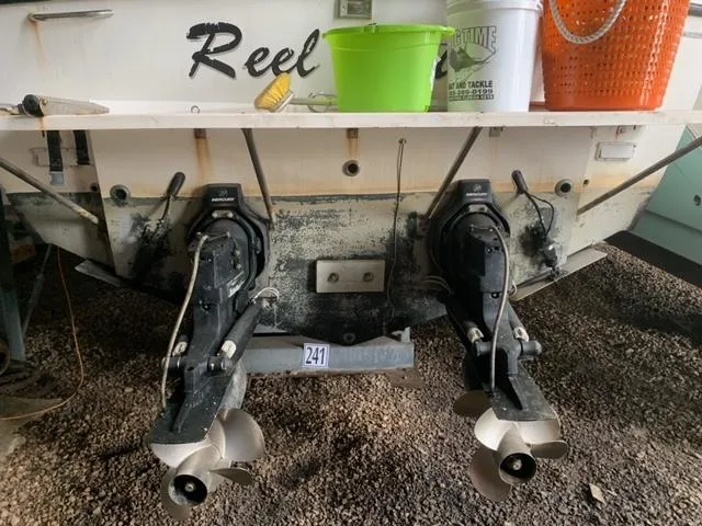 Slide: The Image of 2001 Carolina Classic 28 boat stern with dual propellers and maintenance equipment. - 36