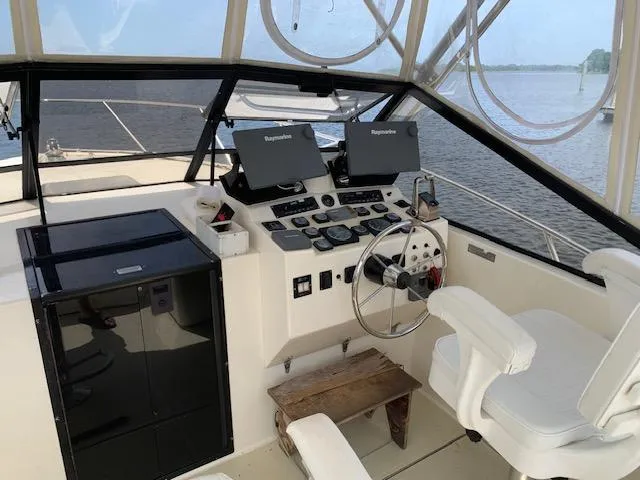 Slide: The Image of Helm of 2001 Carolina Classic 28 boat with navigation equipment and white seating. - 4