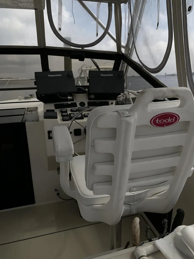 Slide: The Image of Interior helm of 2001 Carolina Classic 28 boat with navigation equipment and Todd captain's chair. - 7