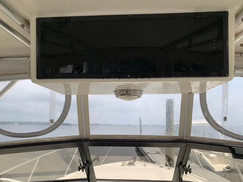 Slide: The Image of Interior view of 2001 Carolina Classic 28 boat cockpit with windshield and overhead compartment. - 9
