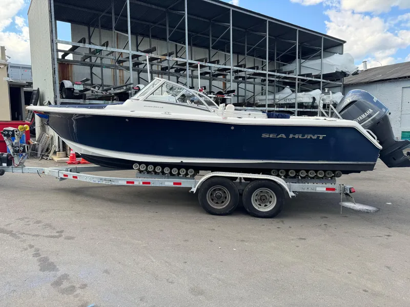 Slide: The Image of 2014 Sea Hunt Escape 235 SE boat on trailer at marina. - 0