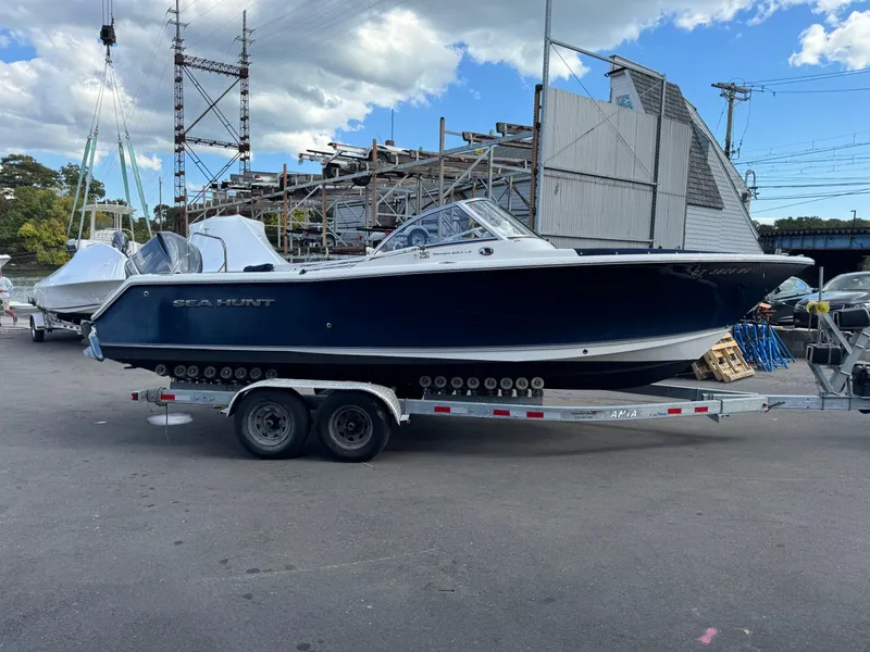 Slide: The Image of 2014 Sea Hunt Escape 235 SE boat on trailer, parked outdoors. - 1