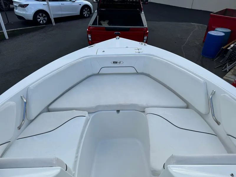 Slide: The Image of 2014 Sea Hunt Escape 235 SE boat interior with white seating and storage compartments. - 10