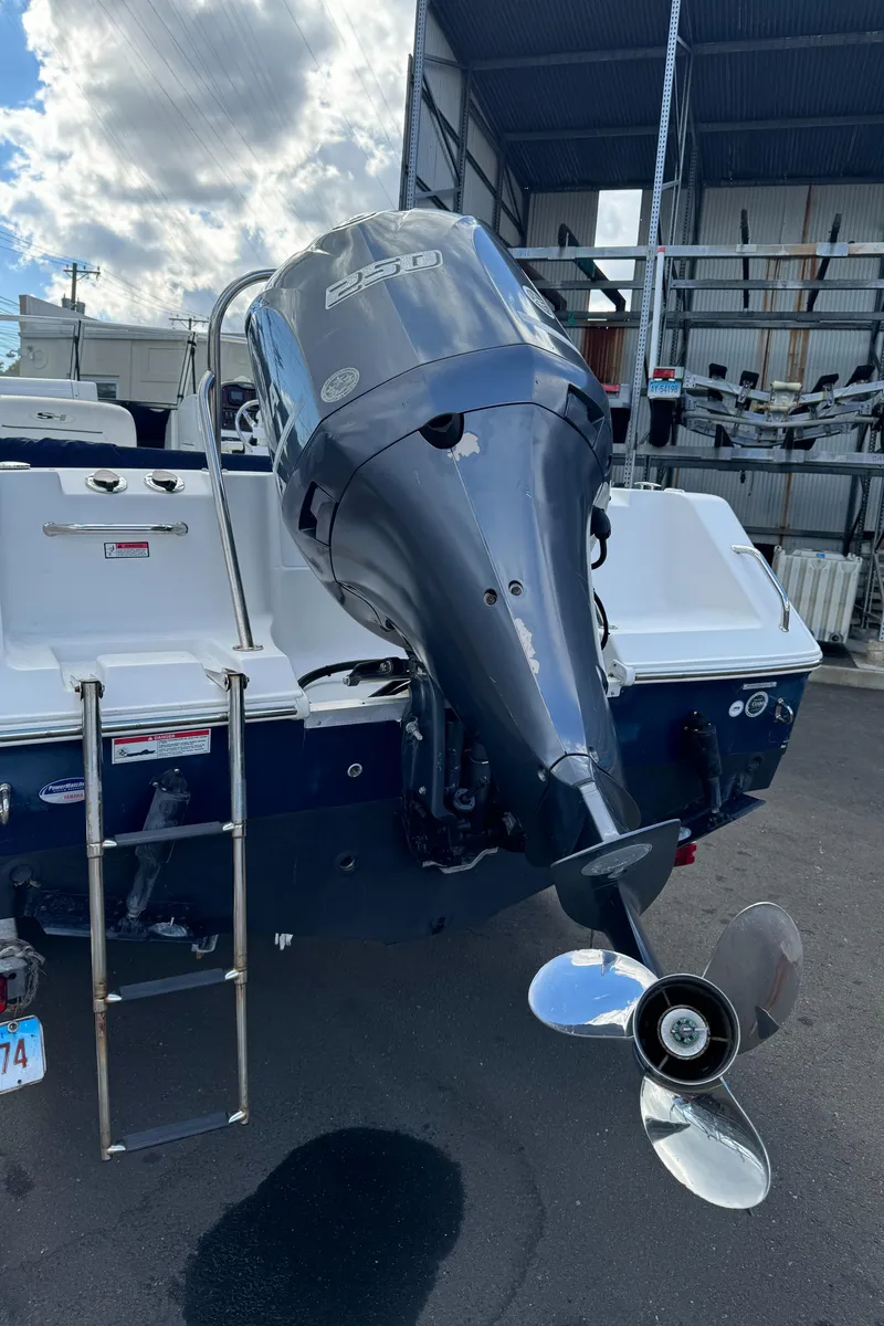 Slide: The Image of 2014 Sea Hunt Escape 235 SE boat with outboard motor and ladder. - 13