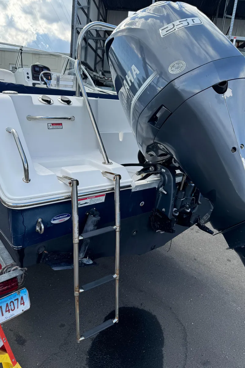 Slide: The Image of 2014 Sea Hunt Escape 235 SE boat with Yamaha 250 engine and swim ladder. - 14