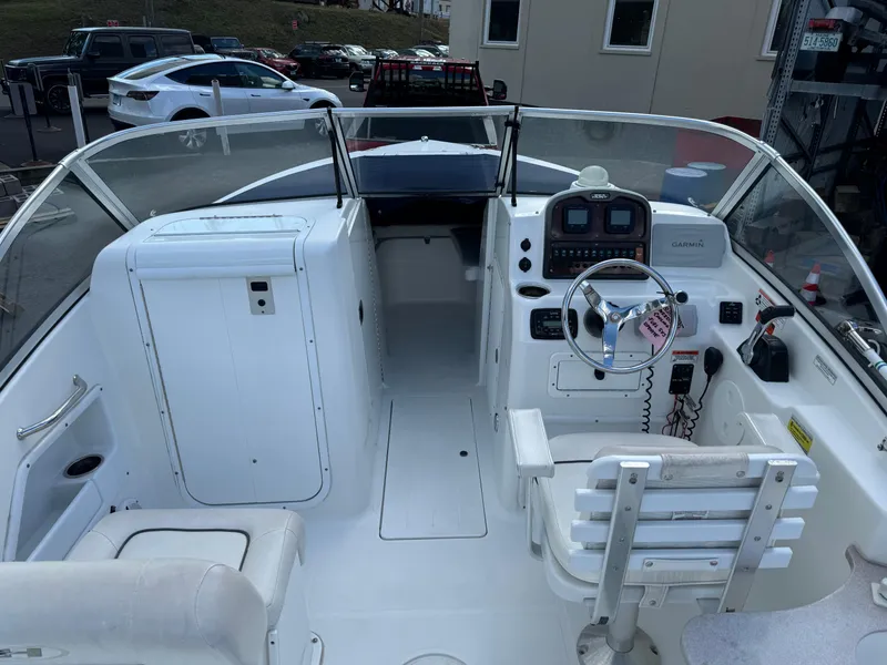 Slide: The Image of 2014 Sea Hunt Escape 235 SE boat interior with steering console and seating. - 2