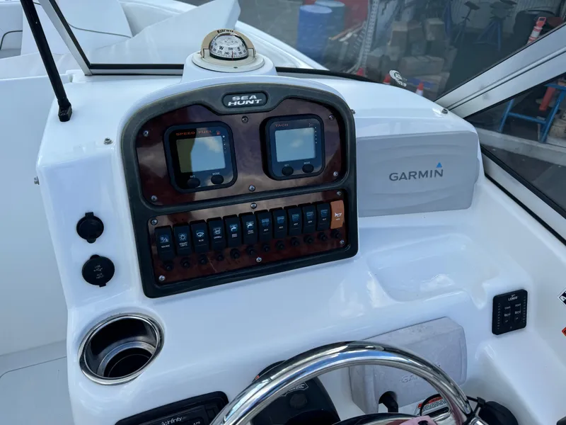 Slide: The Image of 2014 Sea Hunt Escape 235 SE dashboard with Garmin navigation system and controls. - 4