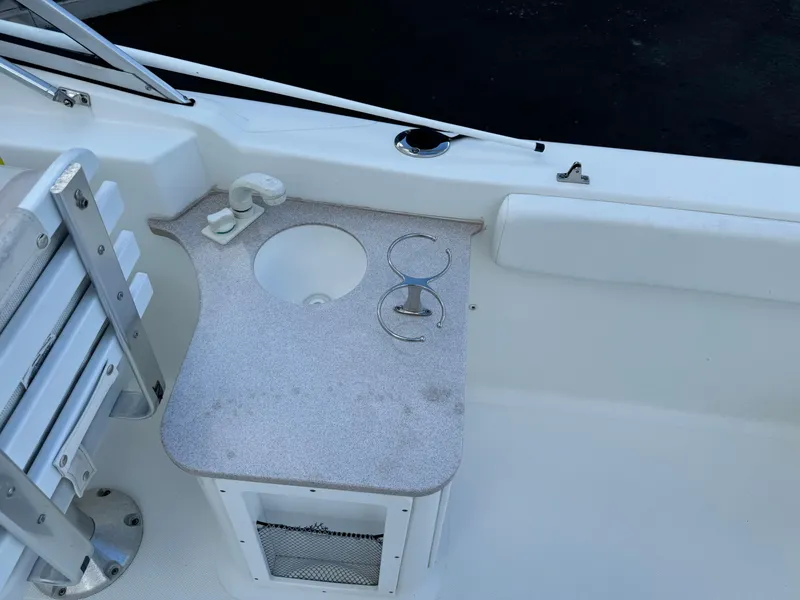 Slide: The Image of 2014 Sea Hunt Escape 235 SE boat interior with cup holders and seating. - 7