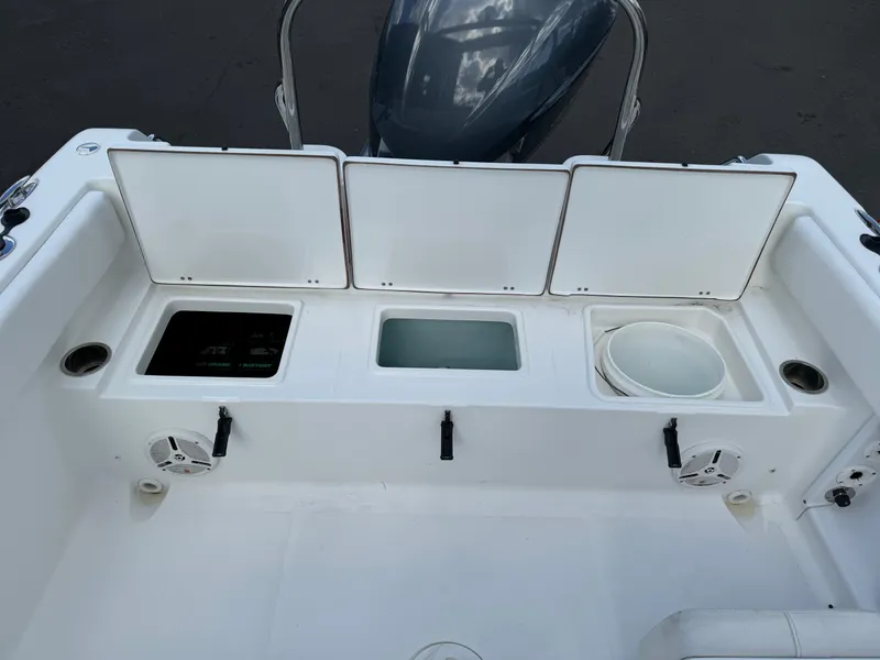 Slide: The Image of 2014 Sea Hunt Escape 235 SE boat storage compartments and seating area. - 8