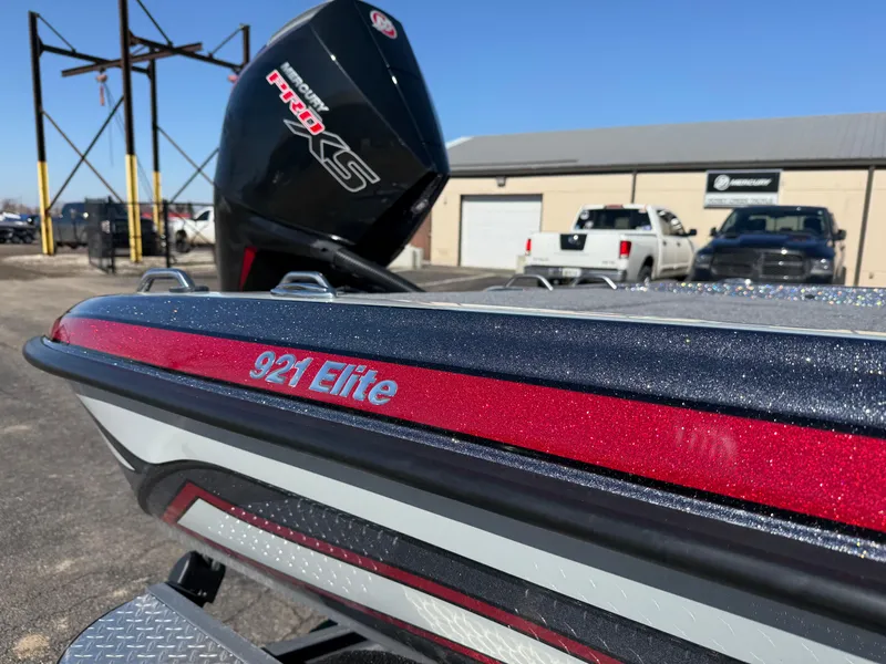 Slide: The Image of 2025 Phoenix 921 ELITE boat with sleek design and powerful engine, parked outdoors. - 10