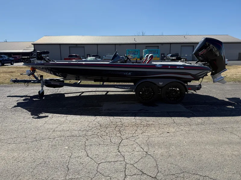Slide: The Image of 2025 Phoenix 921 ELITE boat on trailer, parked outdoors, side view. - 11