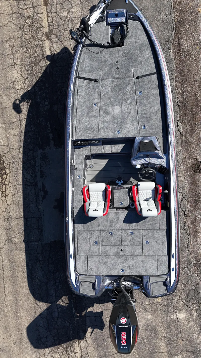 Slide: The Image of Overhead view of 2025 Phoenix 921 ELITE boat on cracked pavement. - 14