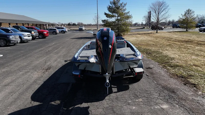 Slide: The Image of 2025 Phoenix 921 ELITE boat parked on asphalt near grass and trees. - 15