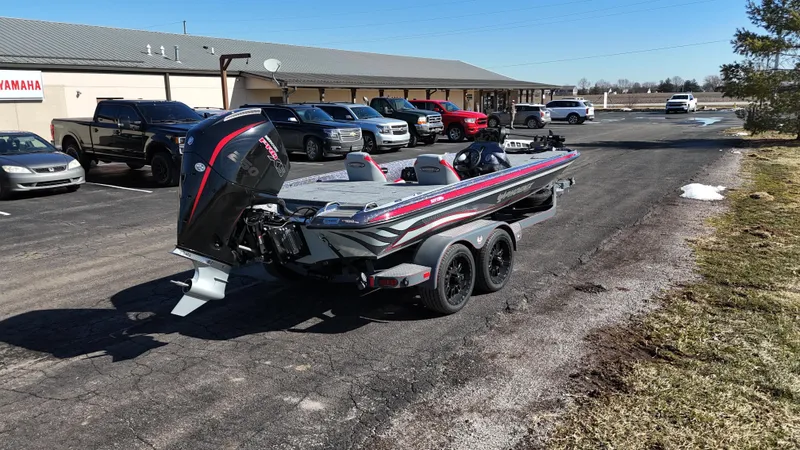 Slide: The Image of 2025 Phoenix 921 ELITE boat on trailer in parking lot, surrounded by vehicles. - 17