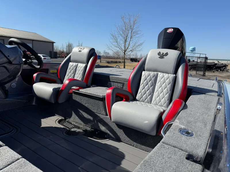 Slide: The Image of 2025 Phoenix 921 ELITE boat interior with gray and red seats, outdoor setting. - 22