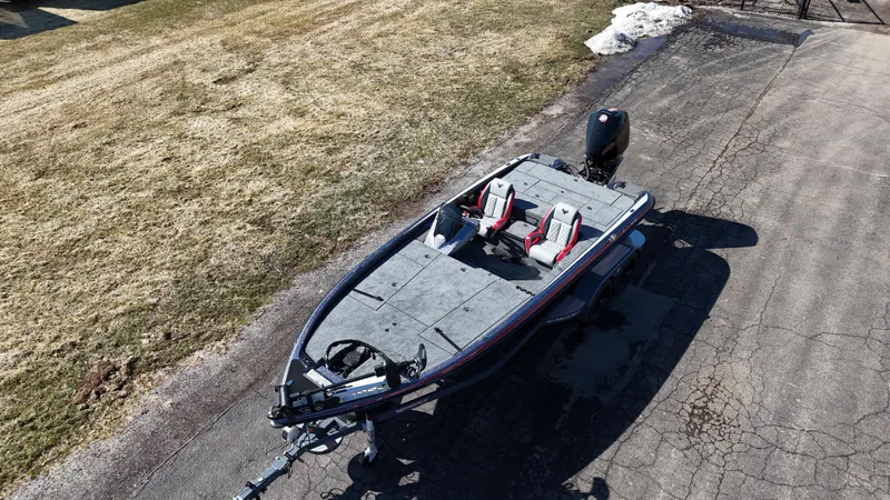 Slide: The Image of 2025 Phoenix 921 ELITE fishing boat on a paved surface, featuring dual seats. - 5