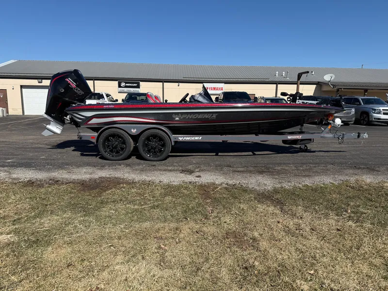 Slide: The Image of 2025 Phoenix 921 ELITE boat on trailer, parked outdoors, side view. - 6