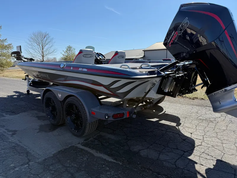 Slide: The Image of 2025 Phoenix 921 ELITE boat on trailer, featuring sleek design and powerful engine. - 8